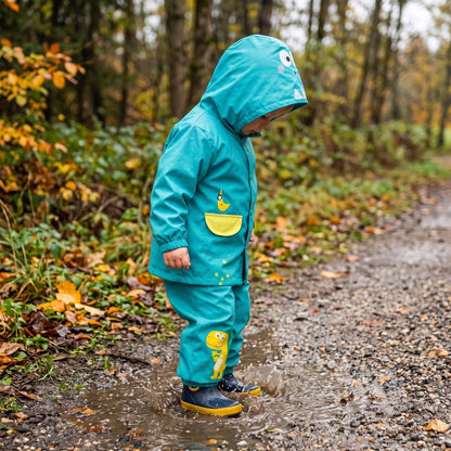 Kinder-Regenanzug mit Kapuzenjacke und Hose in Blau mit Dinosaurier-Motiv und in Rosa mit Einhorn-Motiv